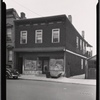 Two story frame building with vacant storefront: Queens