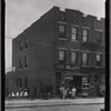 Apartment row with storefronts; J. Brasino Candy Store: 107-04 Otis Ave. - Van Doren St., Queens