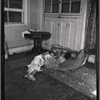 Interior view with two children sleeping on cushions on floor