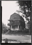 Dutch colonial style shingled house