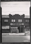 Row houses with storefronts; Skovron's Department Store: 133-03 -07 Cross Bay Blvd-133Av-134 Av, Queens