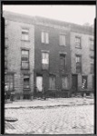 Brick tenements; cobble stone street