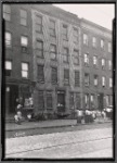 Vacant & renovated tenements; children playing on sidewalk: Manhattan