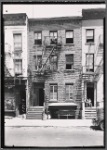 Row houses; man and child on stoop