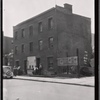 Vacant brick building; men loitering