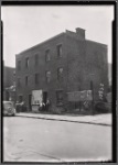 Vacant brick building; men loitering