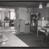 Kitchen interior with "Quality" stove and view into living room