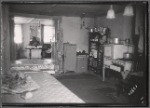 Kitchen interior with "Quality" stove and view into living room