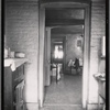 Railroad apartment interior view from kitchen looking into bedroom