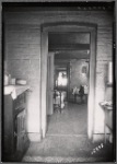 Railroad apartment interior view from kitchen looking into bedroom