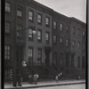 Brick row houses with residents on stoops