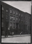 Brick row houses with residents on stoops