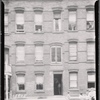 Brick row houses with inspectors in doorway