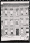 Brick row houses with inspectors in doorway