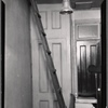 Interior hallway with ladder to attic