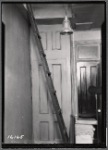 Interior hallway with ladder to attic