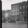 Row houses and storefronts; Ideal Barber Shop (So. Elmhurst Modern): 83-06 -12 [street unknown], Queens]