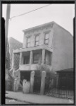 Three story stucco house with garage
