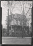 Victorian woodframe house with porch and for sale sign