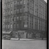 Tenement and storefronts; Rt NY 1A road sign: 1st Ave- E. 104th St., Manhattan