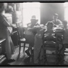 Well appointed kitchen with mother watching six children at table