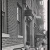 Apartment building with sign for Rev H. A. Lipschitz, Marriage Performer