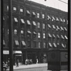 Tenement row with storefronts; Cider Cabin; National Biscuit Co. truck