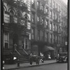 Tenements & storefronts with residents on street