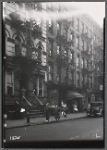 Tenements & storefronts with residents on street