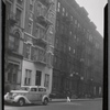 Tenement row with for rent signs; parked taxi: Manhattan