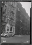 Tenement row with for rent signs; parked taxi: Manhattan