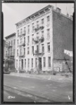 Tenement row, upper Manhattan; man sorting through debris: Manhattan