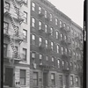 Tenement row; sign for Ice, Coal, & Wood; children outside: Manhattan