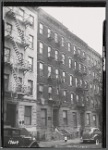 Tenement row; sign for Ice, Coal, & Wood; children outside: Manhattan