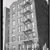 Apartment house; residents outside with children: Bronx
