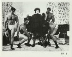 Unidentified musclemen in "Boys Talk" scene from Brand X