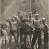 Group of children, mostly boys, gathered under sprinkler, in East Harlem, New York City
