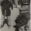 105th Street - Two boys playing with roller skates, each wearing a single roller skate on their right foot, East Harlem, New York City