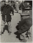 105th Street - Two boys playing with roller skates, each wearing a single roller skate on their right foot, East Harlem, New York City