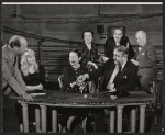 Director Garson Kanin [standing at table], Diane Cilento [seated at table left], Ruth Gordon [seated at table middle], Zero Mostel [seated at table right], Mildred Natwick [background left], Sam Levene [background middle] and Ernest Truex [background right] in rehearsal for the stage production of The Good Soup