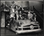 Publicity photo of Treat Williams (holding steering wheel) and the cast from the stage production Grease