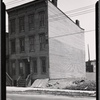 Vacant wood frame tenement with adjacent vacant lot : Queens?