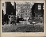Shabby houses and junk across street from new apartment house. Washington, D.C.