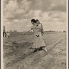 Mrs. Howard shows the beginning of a garden to a neighbor