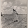 Mrs. Howard shows the beginning of a garden to a neighbor