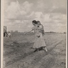 Mrs. Howard shows the beginning of a garden to a neighbor