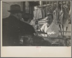 Interior of a grocery store showing the meat counter