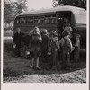 The  children from Dead Ox Flat get off the bus at the school yard. Ontario, Malheur County, Oregon. General caption number 67-1V