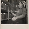 A rehabilitation farmer living near Kinston, North Carolina, with some of the food he produced and stored under his FSA farm and home management plan