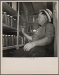 A rehabilitation farmer living near Kinston, North Carolina, with some of the food he produced and stored under his FSA farm and home management plan
